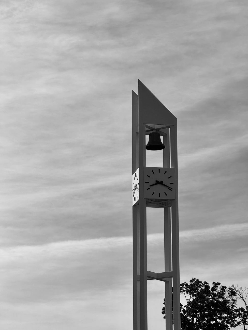 University clock tower against sky, black and white